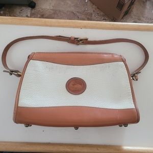 Dooney and Bourke tan & white all weather leather purse.  With adjustable strap